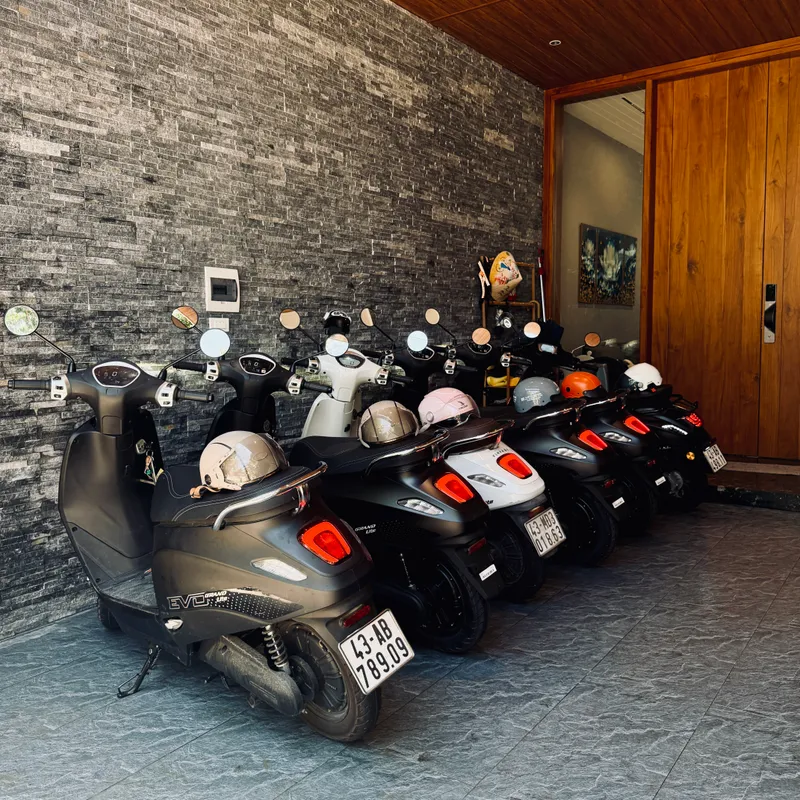 Electric scooters lined up in the garage with helmets